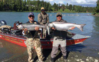 Here are a couple examples of the king salmon waiting for you in Alaska two men holding up king salmon in front of a boat