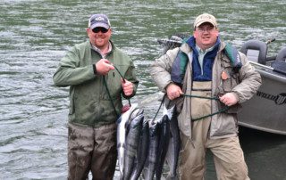This is one more example of the fish that you can catch with our Alaska fishing guides Two men showing off their catch of sockeye salmon