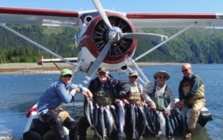 Load up on sockeye salmon when you join us for a fly in Alaska fishing trip Group of 5 people displaying their fishing catches