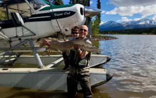 group-angler-posing-pike-fish-wade-plane-2021-11-16 Click this image button to go to the "Northern Pike" page