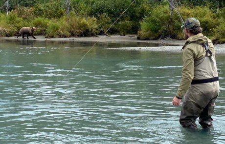 dupe-single-angler-casting-wade-2022-3-17 Angler wading in a stream, casting into the distance.