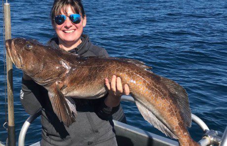 dupe-single-angler-posing-ling-cod-fish-boat-2022-3-17 An angler holding a ling cod caught offshore