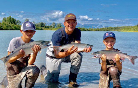 group-angler-child-posing-silver-salmon-fish-wade-2022-3-17 An angler two children showing off their silver salmon catch.