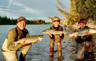 group-angler-child-posing-sockeye-salmon-fish-bank-2022-3-17 An angler and two children proudly display their caught sockeye salmon.