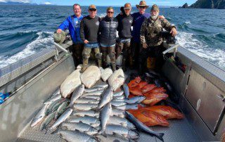 group-angler-posing-varied-fish-boat-2022-3-18 A group of anglers posing in the back of their boat with their large offshore fishing catch