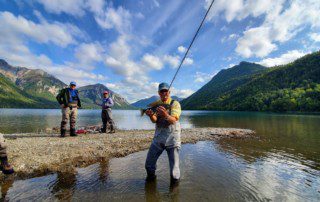 single-angler-posing-arctic-grayling-fish-wade-2022-3-17 An angler holding a freshly caught arctic grayling