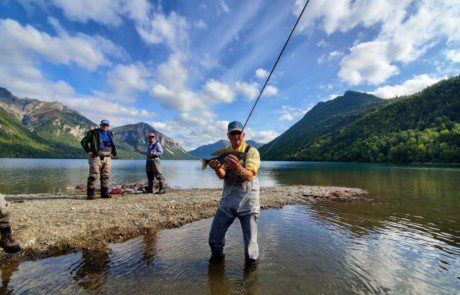 single-angler-posing-arctic-grayling-fish-wade-2022-3-17 An angler holding a freshly caught arctic grayling