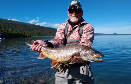 single-angler-posing-large-lake-trout-fish-wade-2022-3-17 Angler holding large lake trout.