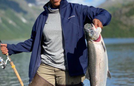 single-angler-posing-silver-salmon-fish-2022-5-13 An angler displaying a large rainbow trout she caught.