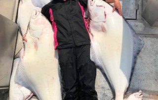 single-angler-posing-laying-halibut-fish-boat-2022-5-13
